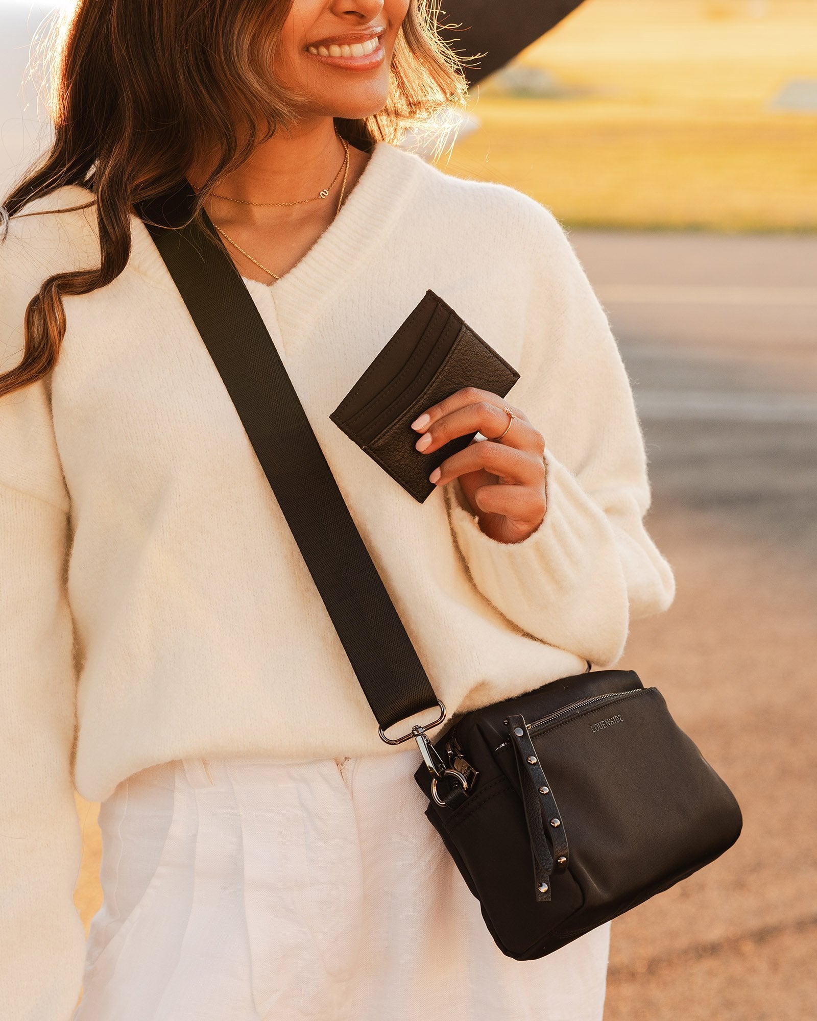 The Louenhide Rowie Nylon Crossbody Bag is the practical, everyday accessory you've been searching for. Embrace an organized dream with multiple internal and external pockets and a stylish matching cardholder. The Rowie's minimalist&nbsp;design is enhanced by the gunmetal detailing - adding the perfect touch of contemporary edge to its classic silhouette.&nbsp; Whether you're exploring the city or embarking on an adventure, this crossbody bag effortlessly complements your capsule wardrobe.