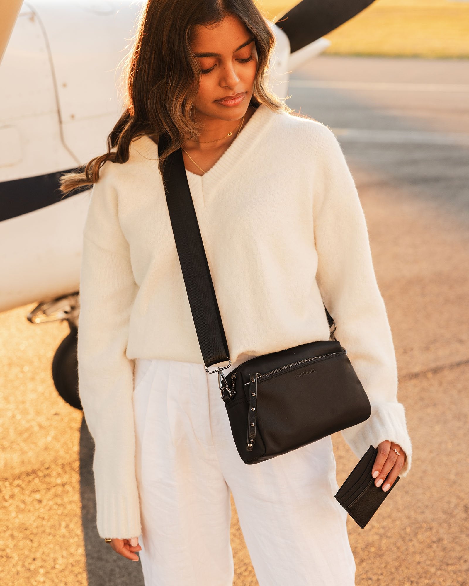 The Louenhide Rowie Nylon Crossbody Bag is the practical, everyday accessory you've been searching for. Embrace an organized dream with multiple internal and external pockets and a stylish matching cardholder. The Rowie's minimalist&nbsp;design is enhanced by the gunmetal detailing - adding the perfect touch of contemporary edge to its classic silhouette.&nbsp; Whether you're exploring the city or embarking on an adventure, this crossbody bag effortlessly complements your capsule wardrobe.