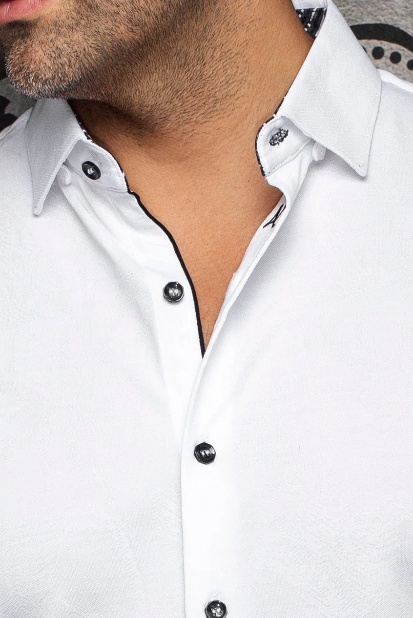Close-up of a white shirt with black buttons on a plain background