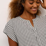 Experience comfort and style with this loose-fit, hip-length blouse. Perfect for daily wear, this short-sleeve, tiny graphic print woven blouse features flattering wing sleeves.