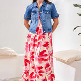 Woman wearing a floral dress with a denim jacket in a minimal indoor setting