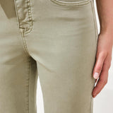 Close-up of light green pants with a neutral background