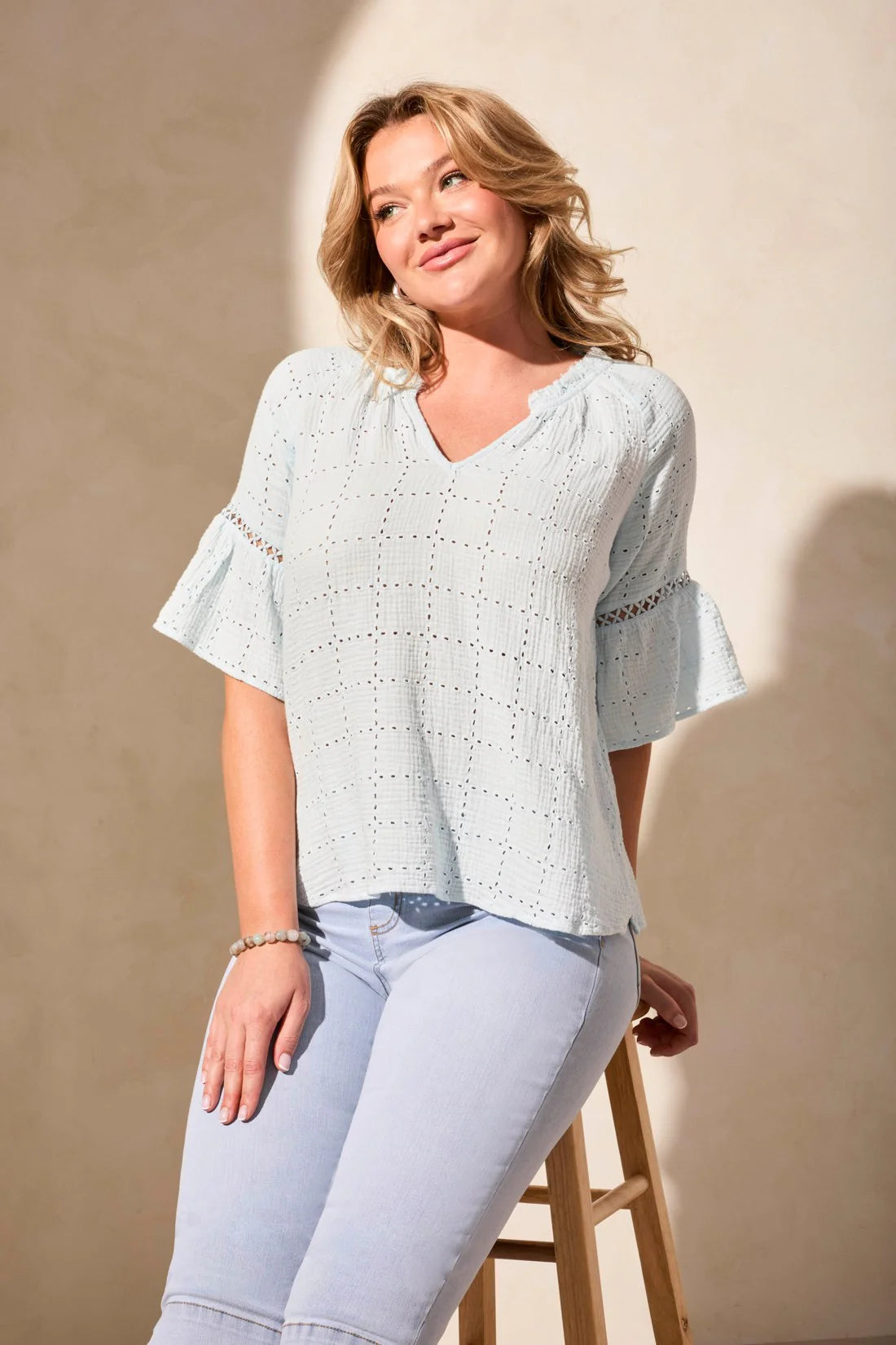 Infuse your day with laid-back elegance in this relaxed blouse, featuring ruffle-finished sleeves adorned with ladder tape detail. A frill accent elegantly frames the poised notch neckline. Made from cotton eyelet gauze, this blouse offers beautiful texture and comfort.