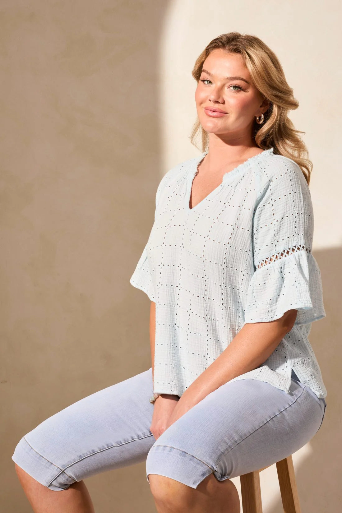 Infuse your day with laid-back elegance in this relaxed blouse, featuring ruffle-finished sleeves adorned with ladder tape detail. A frill accent elegantly frames the poised notch neckline. Made from cotton eyelet gauze, this blouse offers beautiful texture and comfort.