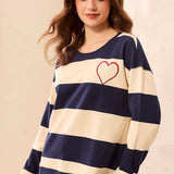 This charming long-sleeve knit pullover features a classic nautical stripe pattern accented by a vibrant embroidered red heart for a playful, romantic touch. Designed with a relaxed drop shoulder and a cozy crew neckline, it offers an effortless silhouette that perfectly balances casual comfort with elevated style.