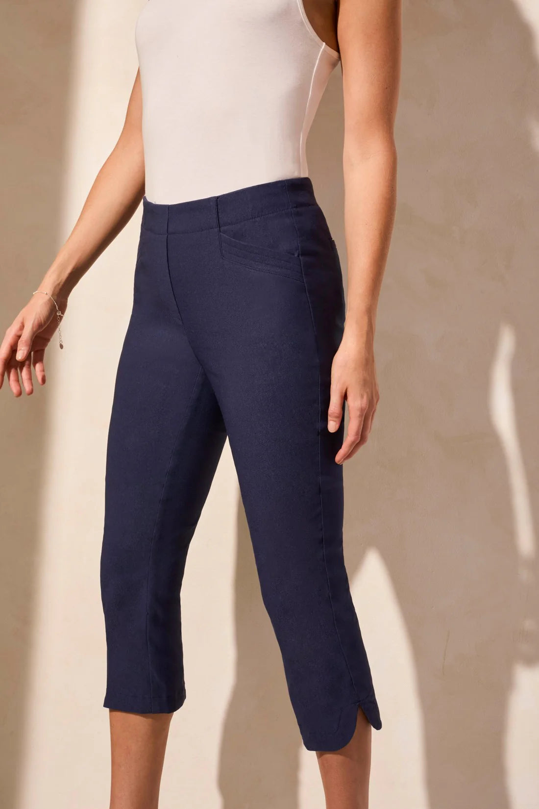 Step out into the sunshine in these classic capri pants, designed with a flattering slim leg fit and Flatten It® Technology to enhance your silhouette. The pull-on style allows for quick and easy dressing, while the stretch twill fabric provides all-day comfort. A rounded side slit adds a stylish accent to the hem.