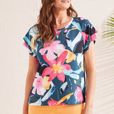 Bold florals define this crew neck top that sports a vibrant print and a 5/8'' neckband. Double ruffle short sleeves unfurl down from either shoulder while raglan armholes and printed rayon jersey fabric add a touch of easygoing flow and comfort.