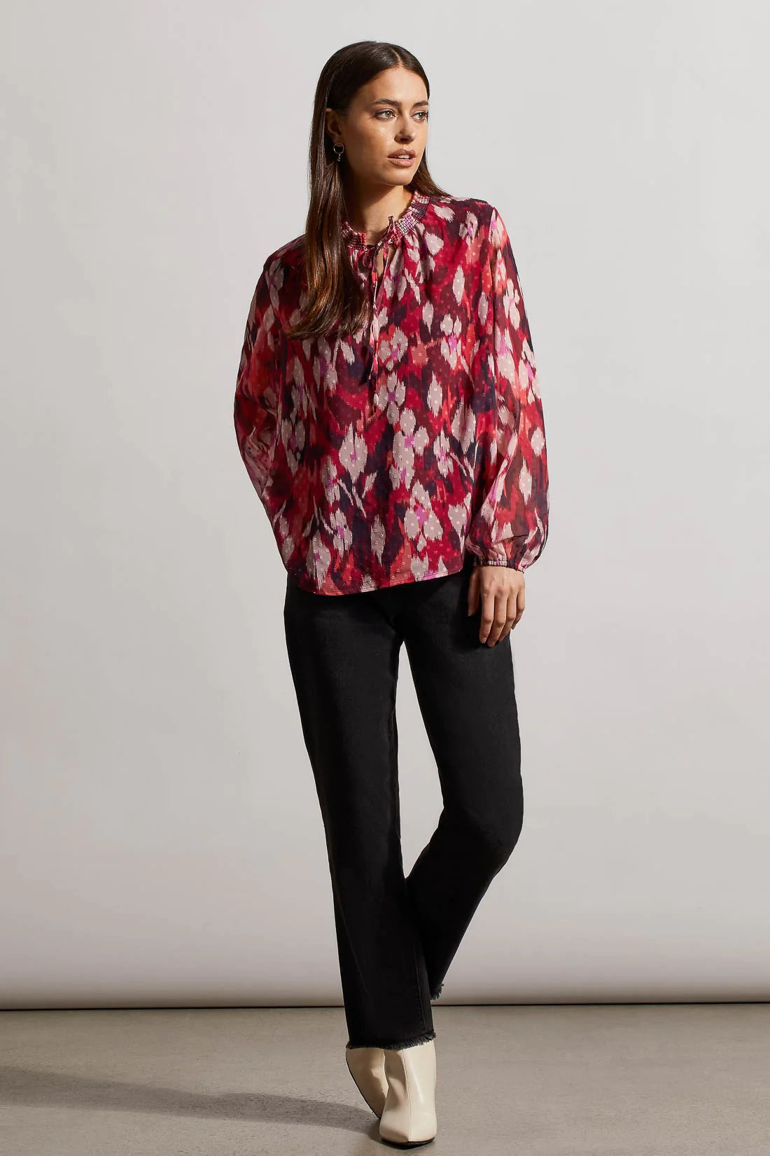 Instantly rejuvenate your everyday wardrobe with this printed blouse that promotes airy breathability with a flowy fit and Swiss dot chiffon fabric. 