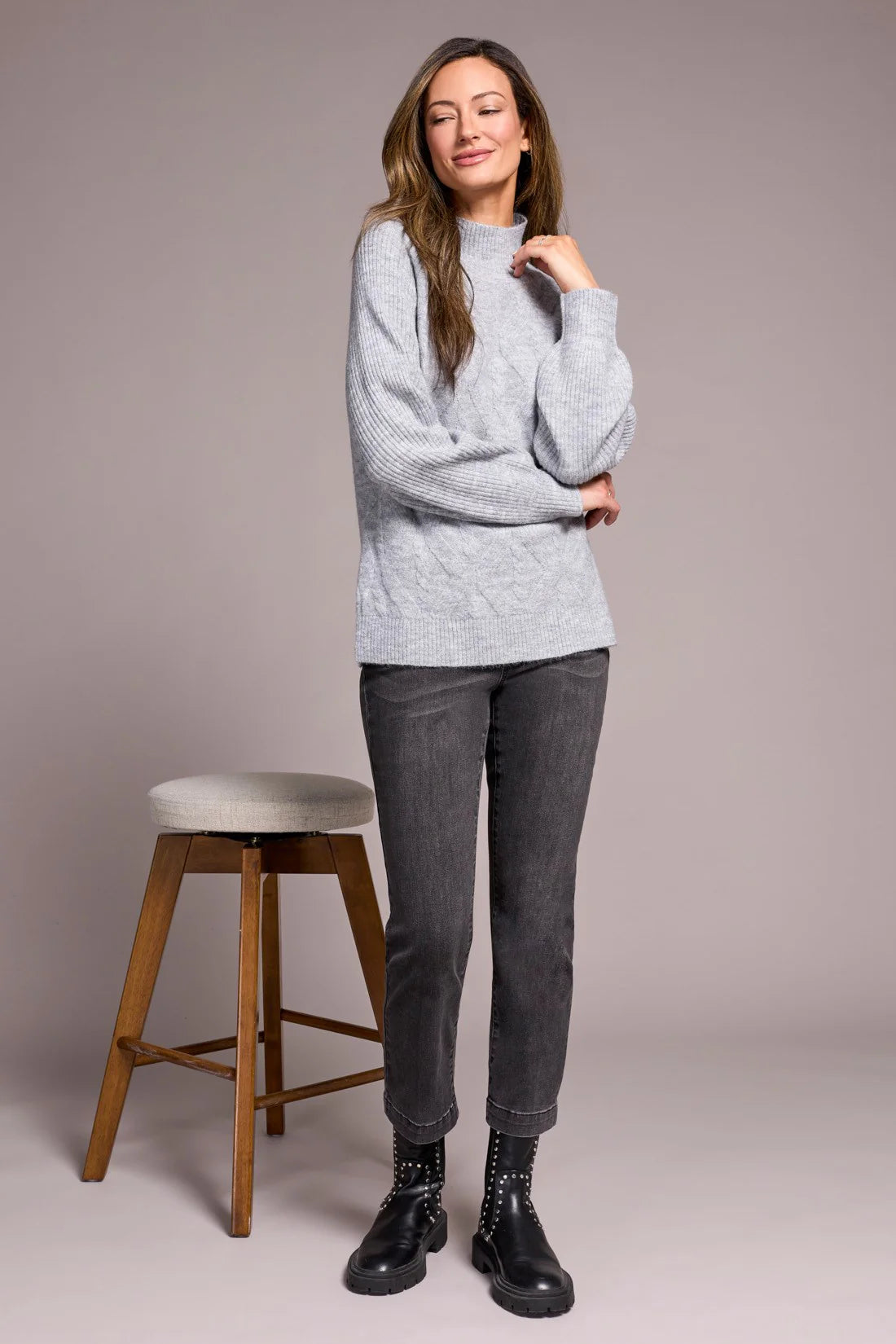 Cooler days call for this cozy sweater, crafted from a soft blend yarn with a rich texture for a luxurious feel. A sleek mock neckline and long puff sleeves add effortless elegance, while fitted cuffs create a refined finish.