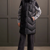 An off-season essential that serves up style points and practical performance. This zip-up puffer vest features a loose fit, chevron quilting, and a hooded neckline that surrounds you with cozy comfort, a 38" long design, front welt pockets, and zippered side seams that allow for more ventilation and moveability when required.