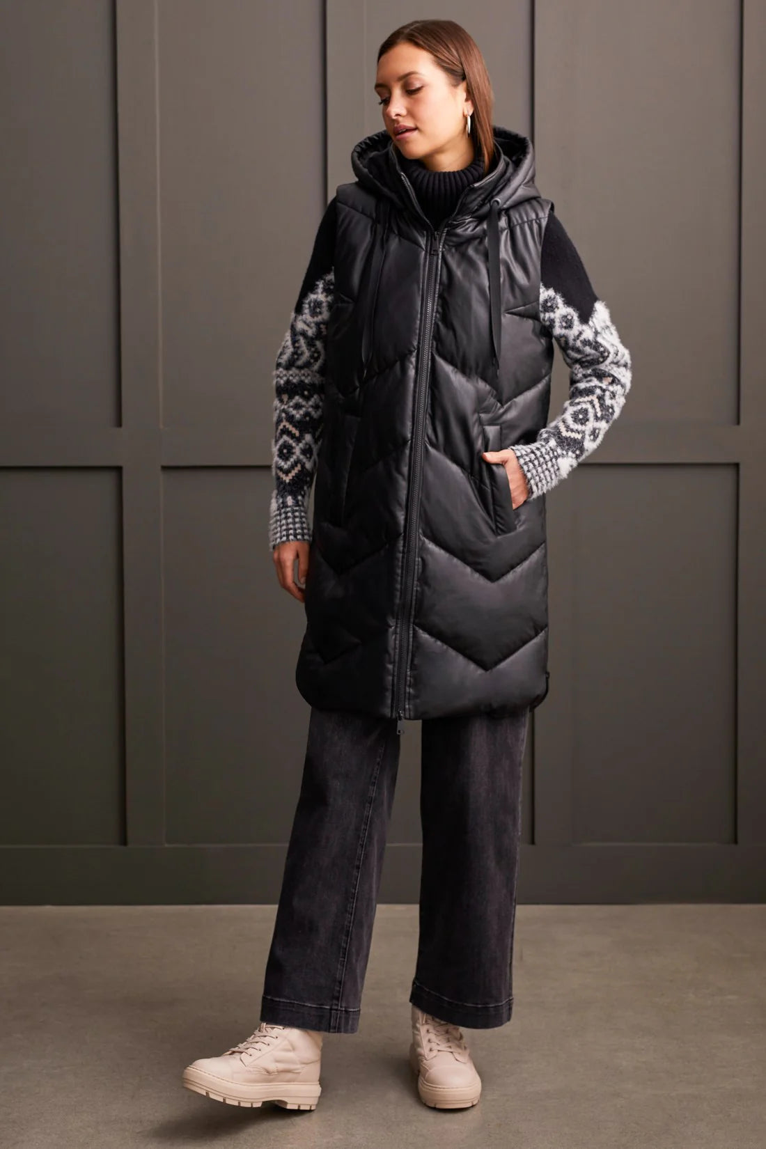 An off-season essential that serves up style points and practical performance. This zip-up puffer vest features a loose fit, chevron quilting, and a hooded neckline that surrounds you with cozy comfort, a 38" long design, front welt pockets, and zippered side seams that allow for more ventilation and moveability when required.