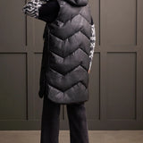 An off-season essential that serves up style points and practical performance. This zip-up puffer vest features a loose fit, chevron quilting, and a hooded neckline that surrounds you with cozy comfort, a 38" long design, front welt pockets, and zippered side seams that allow for more ventilation and moveability when required.