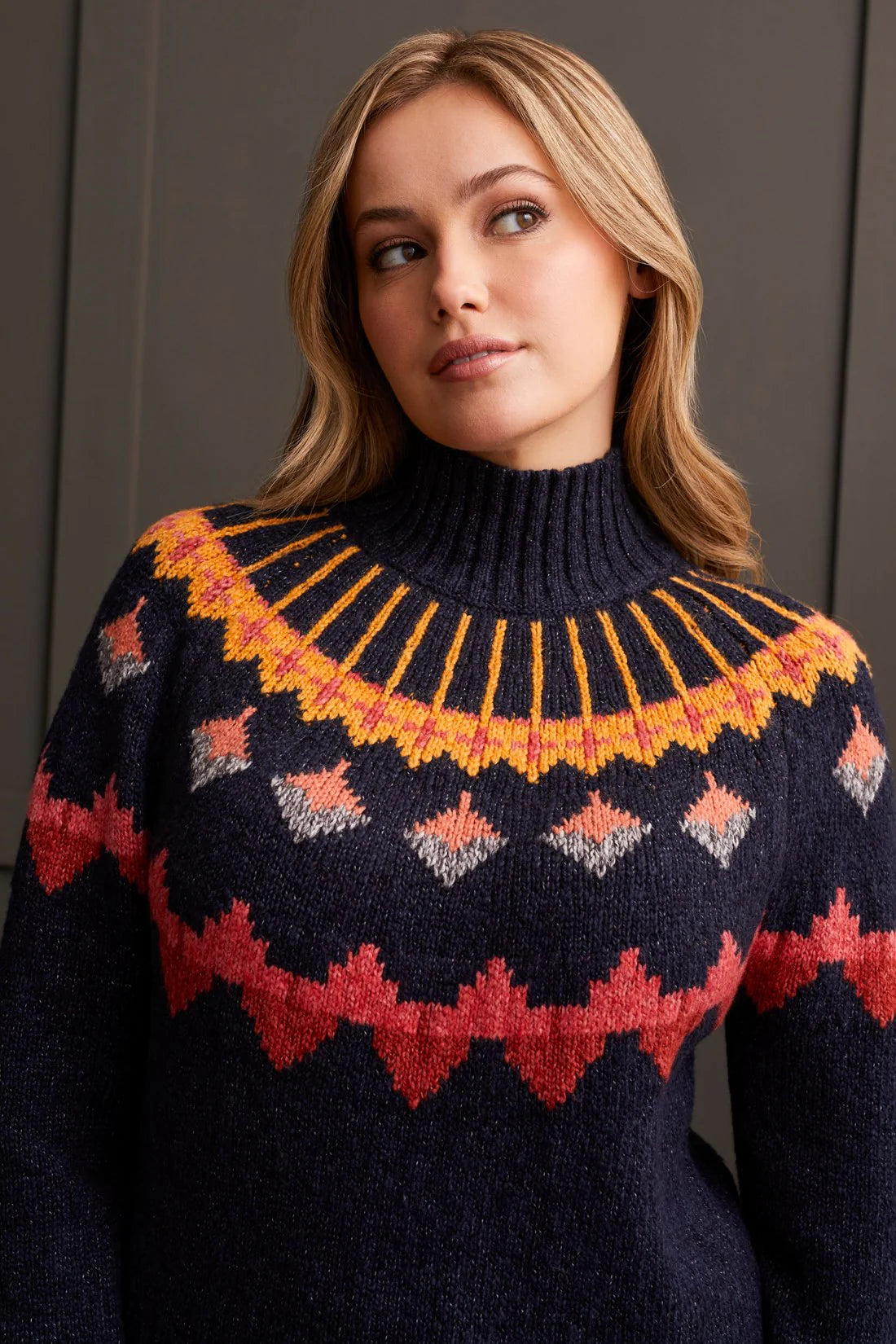 Embrace bold fashion with confidence in this mock neck sweater, featuring vibrant geometric intarsia patterning that adds a pop of colour to chilly days. Designed with a chic pop-over style, long sleeves, and crafted from novelty yarn, it wraps you up in comfort while making a statement with every wear.