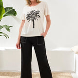 A bold palm placement print makes this crewneck tee a true standout. Crafted in slub cotton for breathable softness, it’s a fresh pop of artistry for your everyday style, finished with a classic fit.