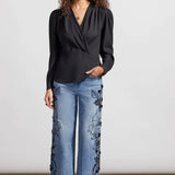 You'll be a vision of captivating cosmopolitan style with this wrap blouse in your collection. 