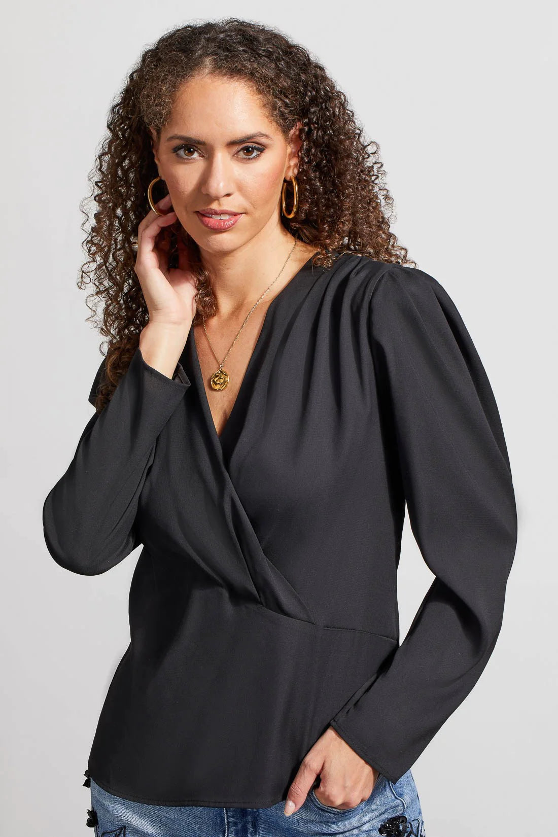 You'll be a vision of captivating cosmopolitan style with this wrap blouse in your collection. 