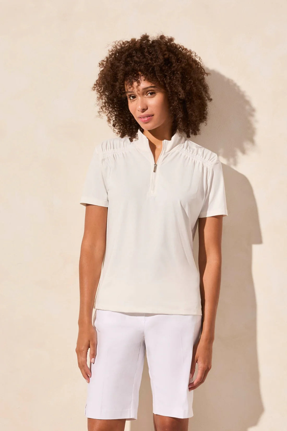 Elevate your sporty charm with this short-sleeve top, crafted from luxuriously soft zigzag pointelle knit. The sophisticated mock neckline is accented by an adjustable zipper, allowing for effortless style and a personalized fit.