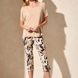 Infuse your style with vibrant personality in these pull-on capri pants, featuring bold printed bengaline fabric. The straight leg design is enhanced by adjustable side vents at the hem, elegantly finished with fabric-covered buttons. Practical front and back pockets complete the look, combining style with functionality.