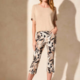 Infuse your style with vibrant personality in these pull-on capri pants, featuring bold printed bengaline fabric. The straight leg design is enhanced by adjustable side vents at the hem, elegantly finished with fabric-covered buttons. Practical front and back pockets complete the look, combining style with functionality.