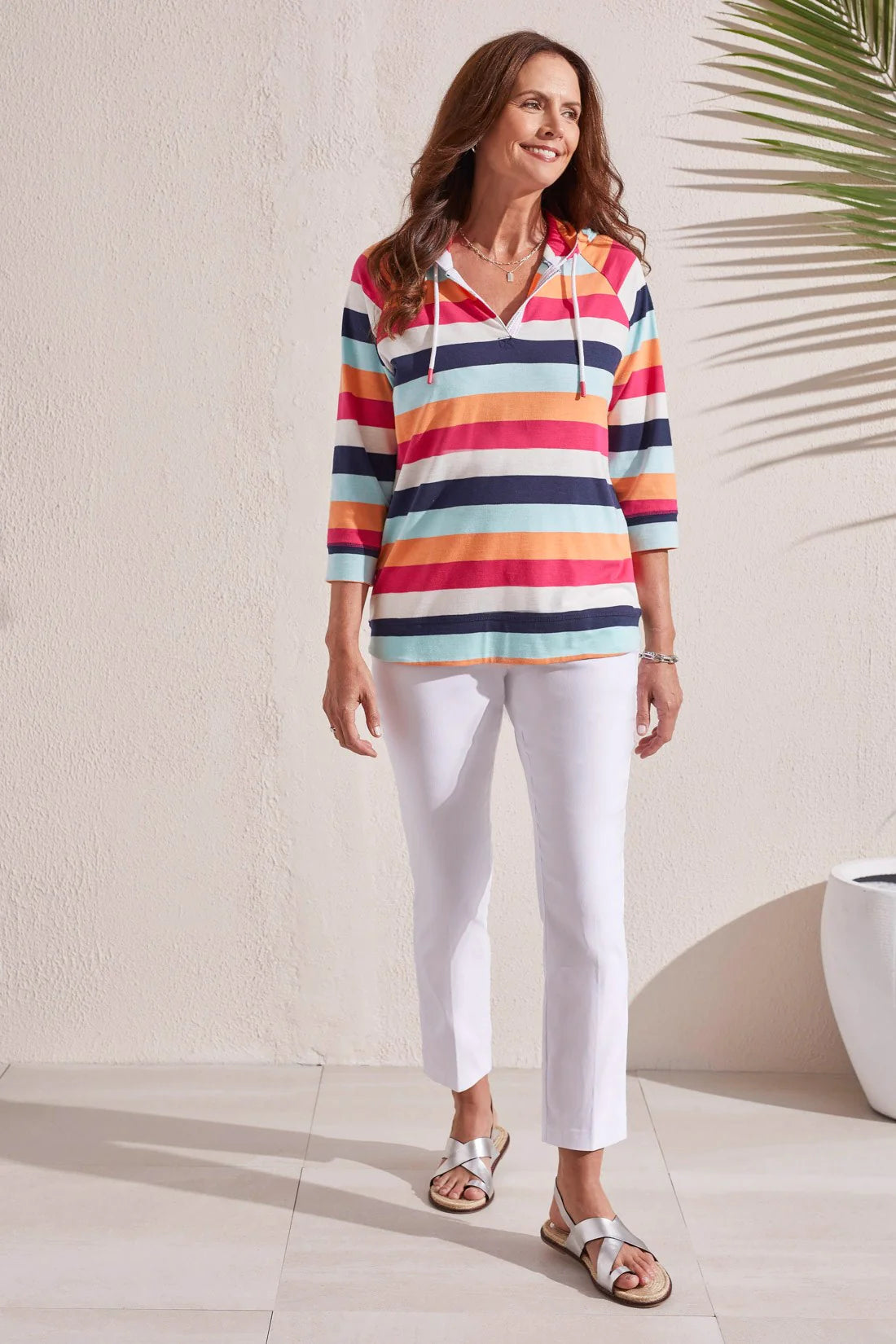 Craving coziness that won't weigh you down? This raglan hoody is ready to check all your boxes with an airy notch neckline, three-quarter sleeves, flattering shirttail hem, and fabric patterned with colourful stripes.