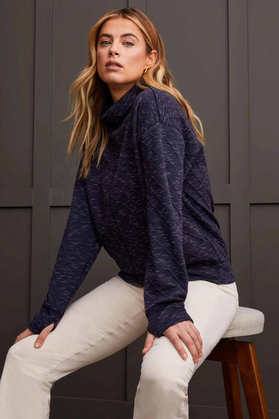 Combining practical performance with timeless everyday style, this funnel neck top is a versatile addition to your wardrobe. The diamond quilted pattern not only provides functional warmth but also adds visual interest to your look. With long drop-shoulder sleeves and stretch-infused fabric, you'll enjoy freedom of movement all day long. Plus, the thumbhole cuffs ensure your hands stay toasty on chilly days.