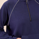 Navy blue pullover with a zipper on a beige background