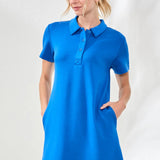 Woman wearing a blue dress with a collar against a white background