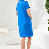 Woman wearing a blue dress in a minimalistic setting