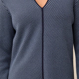 Navy striped long-sleeve top on a neutral background