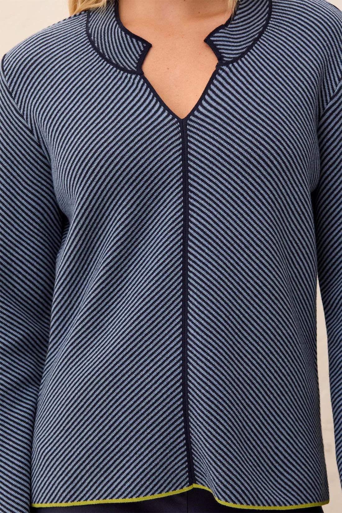 Navy striped long-sleeve top on a neutral background