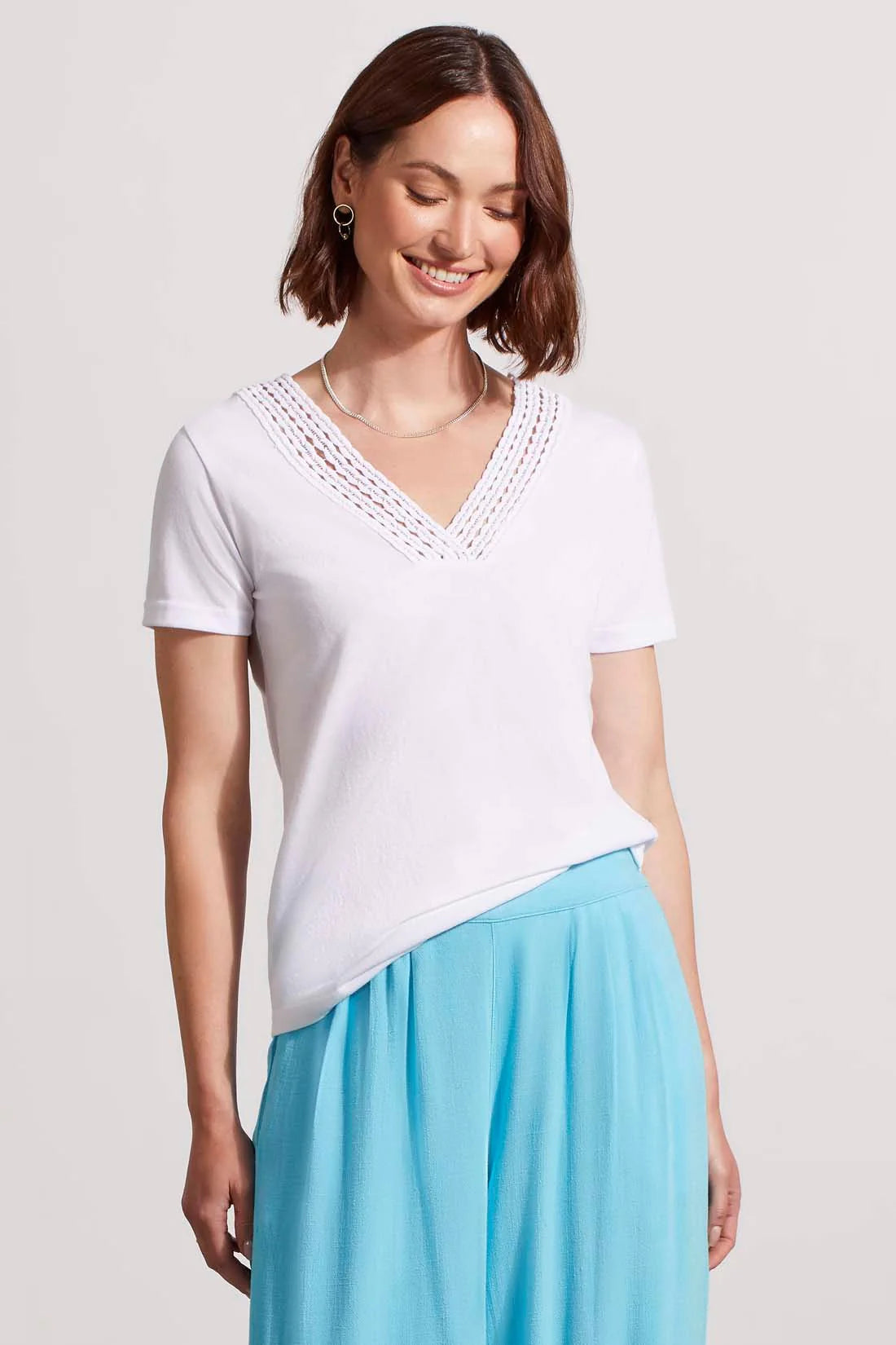 Not your average tee. This short-sleeve top makes a stylish impact with a v-neck outlined in color-coordinated crochet trim. The slub knit fabric is so soft you'll be wearing it as often as possible.