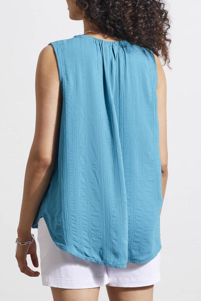 Expertly crafted from lightweight fabric, this Tribal Sleeveless Blouse with Tie is perfect for warm weather. The stylish tribal top with tie detail add a touch of trendy flair to your wardrobe. Stay cool and look effortlessly chic in this lagoon mist coloured blouse.