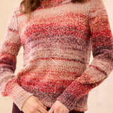 Person wearing a multicolored striped sweater against a beige background