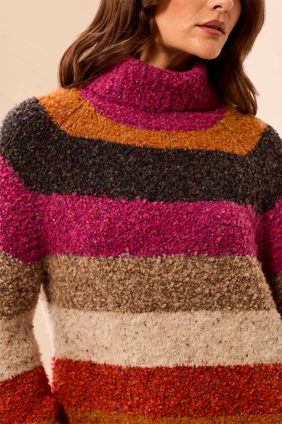 Multicolored striped sweater worn by a person