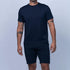 Man wearing a navy blue t-shirt and shorts on a light gray background