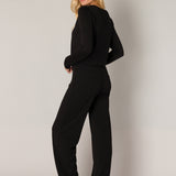 Yarah is a wide-leg trouser in recycled polyester with an elasticated waistband and closed welt pockets on the back panel. 
